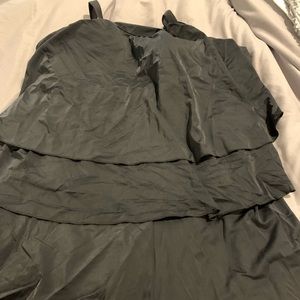 Black romper style one piece swimsuit.